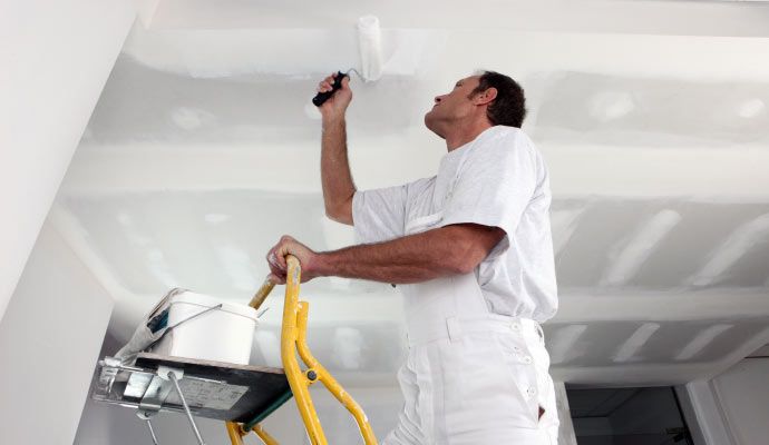 Person painting ceiling in a hotel