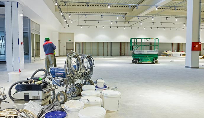 Warehouse being painted by professional painters using specialized equipment