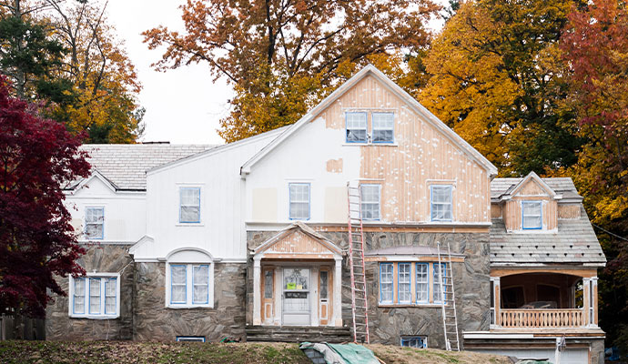 A large house being prepared for exterior painting.