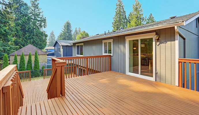 A large, multi-level wooden deck on the back of a house.