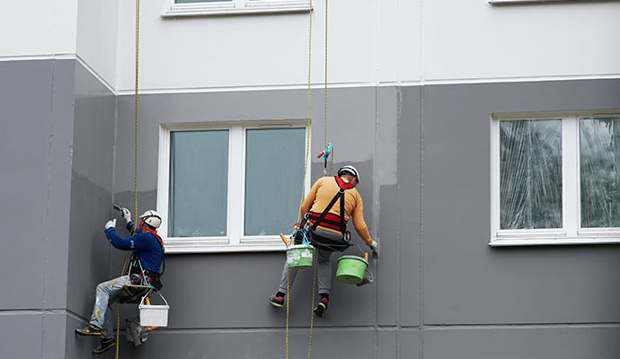 A professional team painting exterior wall