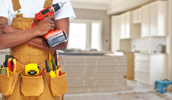 A handyman with a tool belt and a power drill.