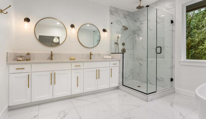 A modern bathroom with white refaced vanity cabinets